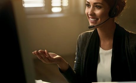 Woman smiling at computer while on a call